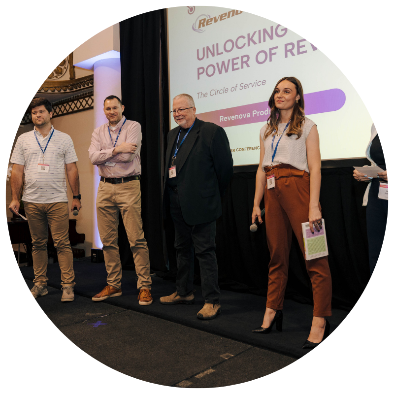 Revenova team standing on stage presenting